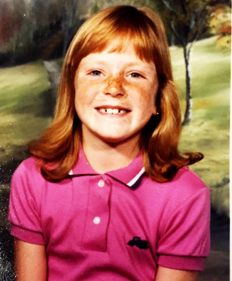 grade school pic of a redheaded freckled face girl