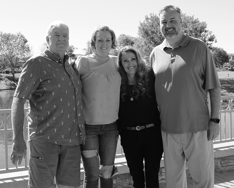 portrait of a four person family in black and white